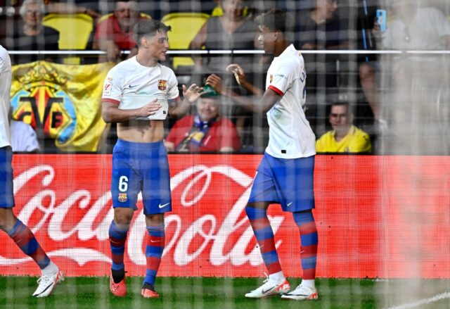 Barcelona winger Lamine Yamal (R) celebrates with team-mate and fellow academy graduate Ga