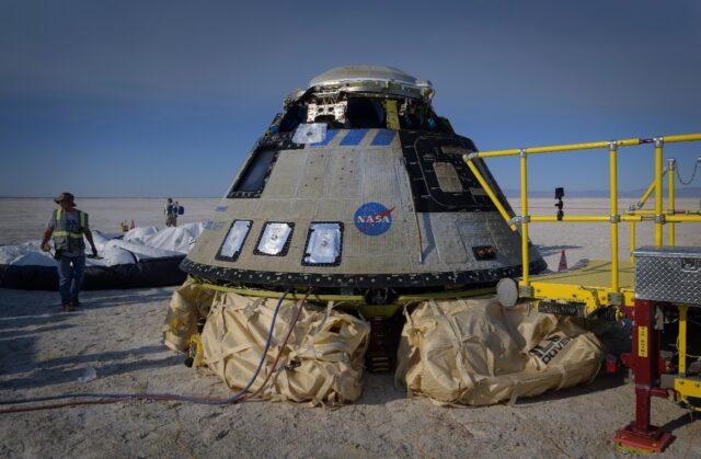Boeing and NASA teams work around Boeing's CST-100 Starliner spacecraft after it landed on