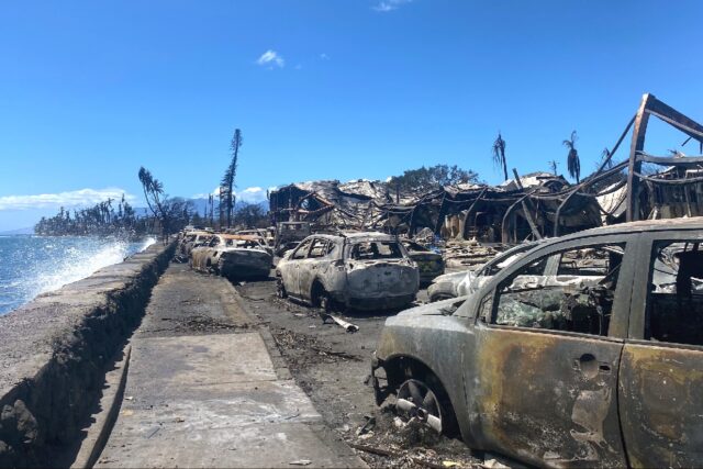 Burned cars and destroyed buildings line the shore in Lahaina, Hawaii