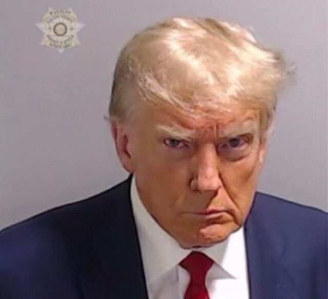 Donald Trump poses in a mug shot taken at the Fulton County Jail in Atlanta -- the first s