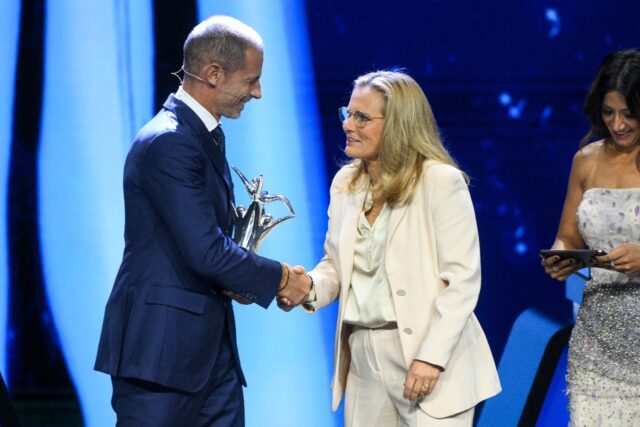 England manager Sarina Wiegman greets UEFA president Aleksander Ceferin after receiving th