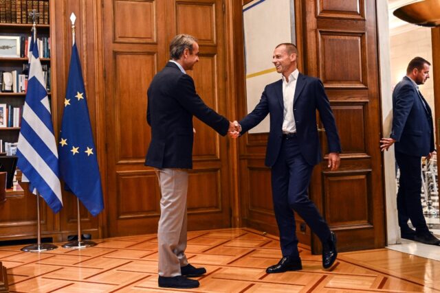 Greek Prime Minister Kyriakos Mitsotakis (left) welcomes UEFA President Aleksander Ceferin