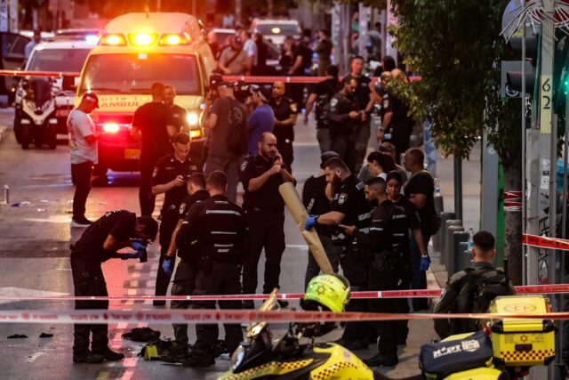 Israeli police gather evidence from the scene of a shooting in commercial hub Tel Aviv whi