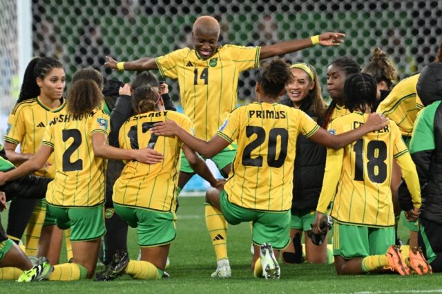 Jamaica's players celebrate qualifying for the next round of the Women's World Cup after k