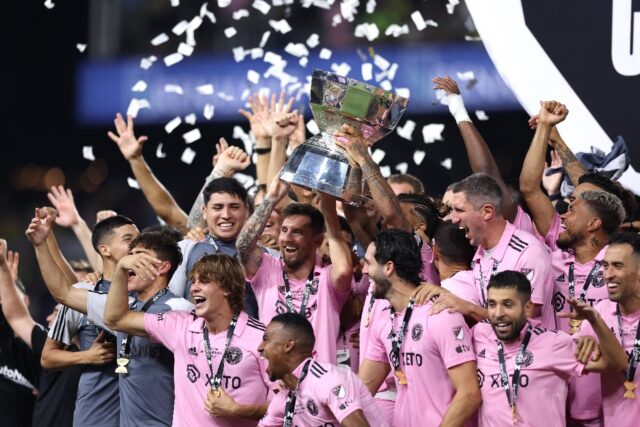 Lionel Messi of Inter Miami hoists the trophy with his teammates after defeating Nashville