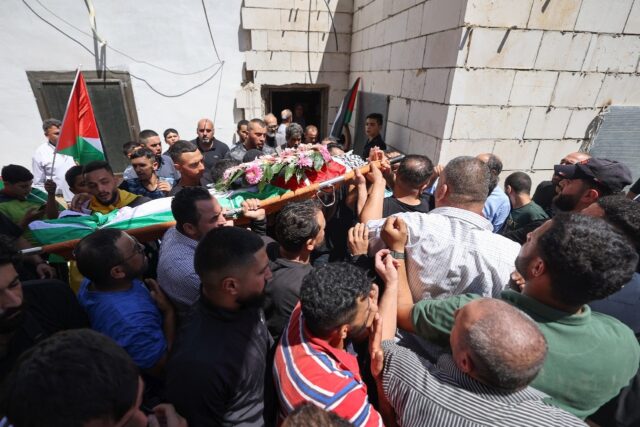 Mourners carry the body of Qusai Jamal Maatan, 19, during his funeral in the occupied West