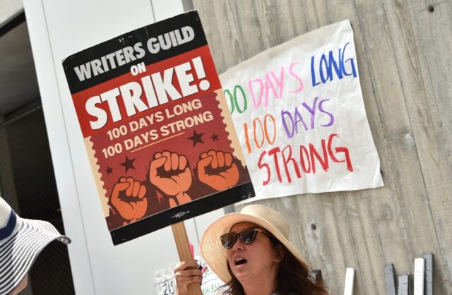 Members of the Writers Guild of America (WGA) walk the picket line on the 100th day of strike outside of Fox Studios -- the two sides will soon return to the negotiating table