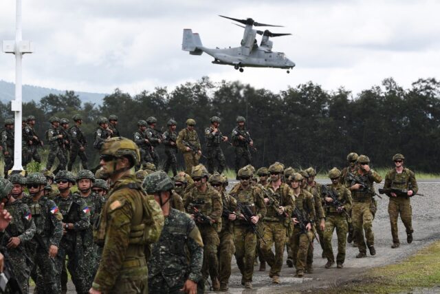 Philippine and Australian soldiers march in formation during a military drill