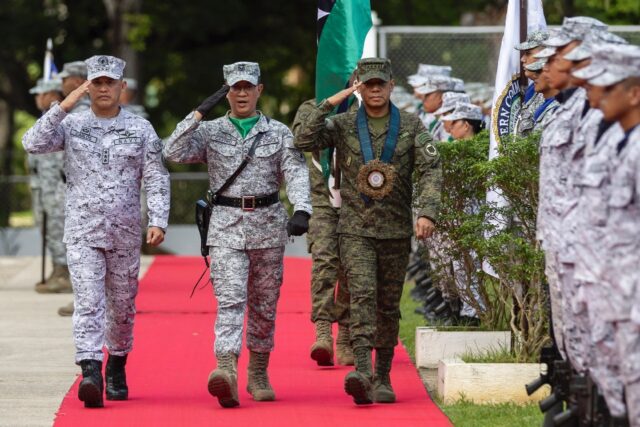 Philippine Vice Admiral Alberto Carlos (L) says Manila will resupply a remote outpost in t