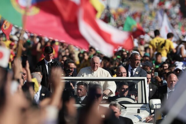 Pilgrims shrieked and waved as the pontiff, surrounded by bodyguards, slowly drove by on h