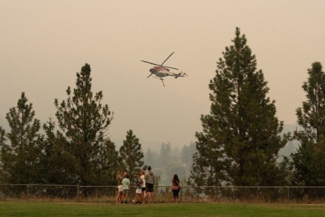 Residents of western Canada scrambled to evacuate as raging wildfires encroached on two me
