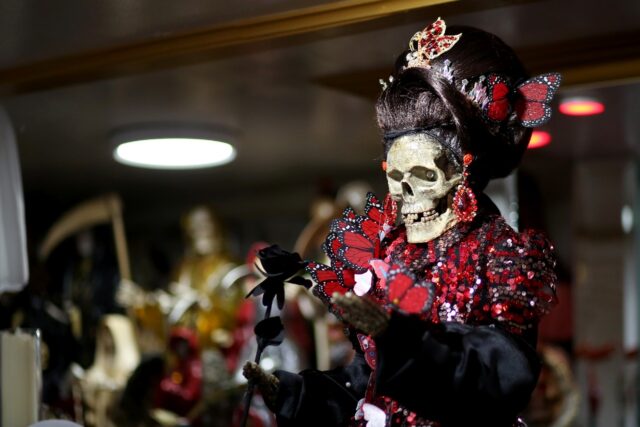 Santa Muerte, or Saint Death, is often portrayed carrying a scythe, a globe or a rose -- a