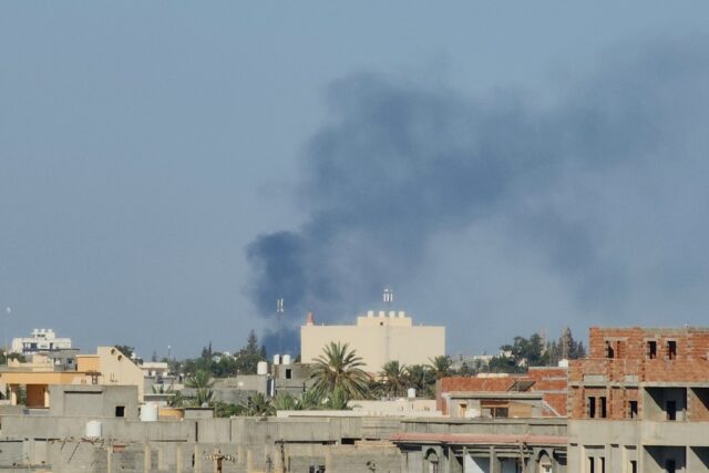Smoke billows over the Libyan capital amid heavy fighting between the two main armed group