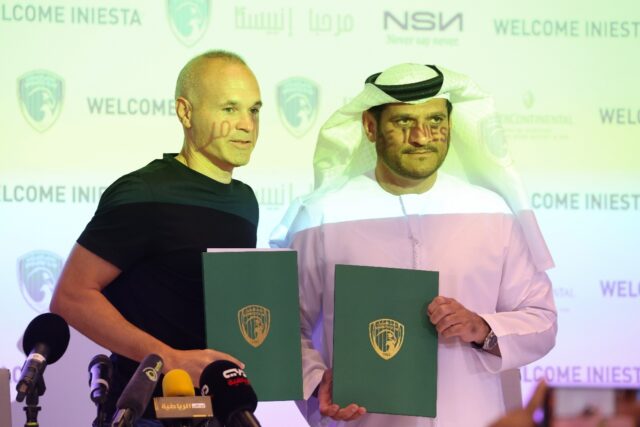 'New page': Spanish midfielder Andres Iniesta with Emirates Club chairman Youssef al-Batra
