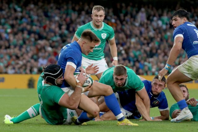 Stong in defence and attack - Ireland flanker Caelan Doris (L) tackles Italy scrum-half St