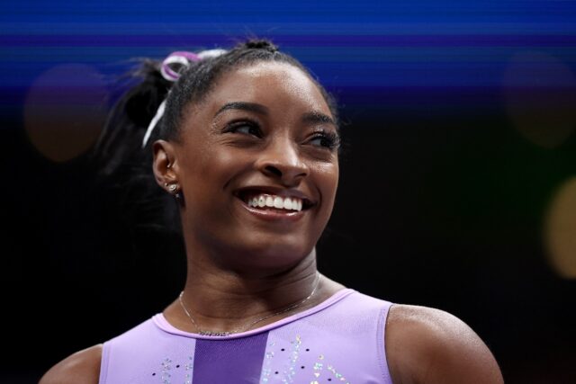 Four-time Olympic champion Simone Biles leads the all-around standings after the first day