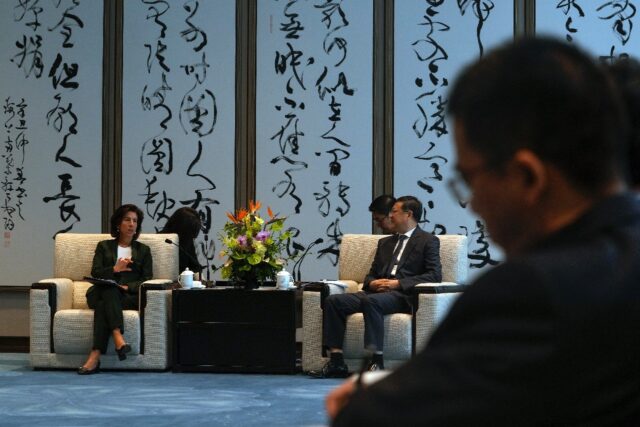 US Commerce Secretary Gina Raimondo (L) talks with Shanghai Party Secretary Chen Jining du