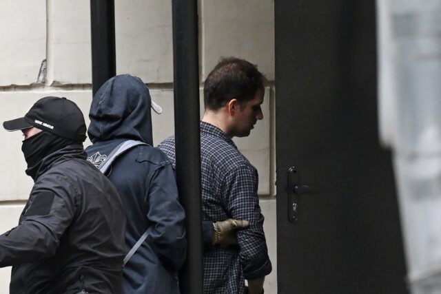 US journalist Evan Gershkovich is escorted outside the Lefortovsky court in Moscow where h