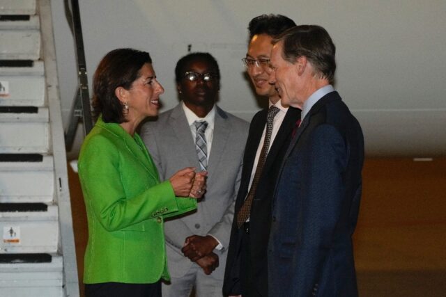 US Secretary of Commerce Gina Raimondo, (L) speaks with Lin Feng, director general of Chin