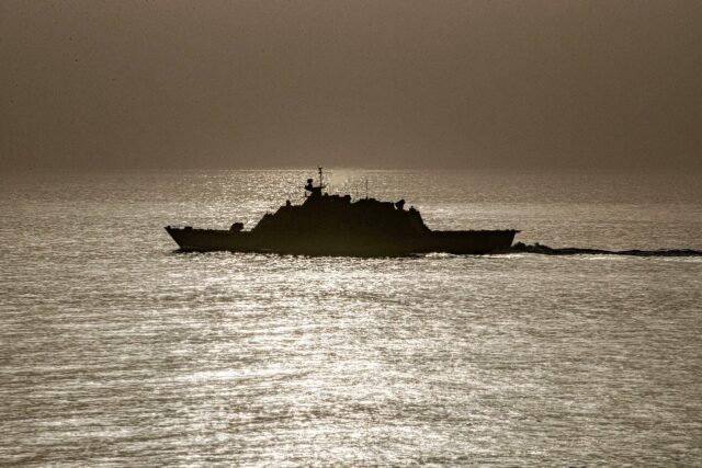 A US warship is seen transiting the Strait of Hormuz