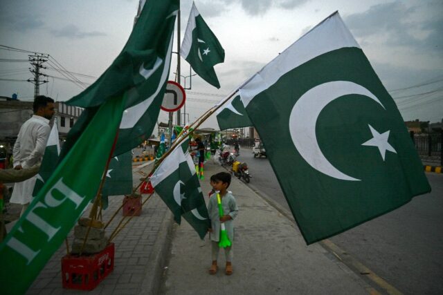 Vendors sell Pakistan flags for Independence Day in Peshawar