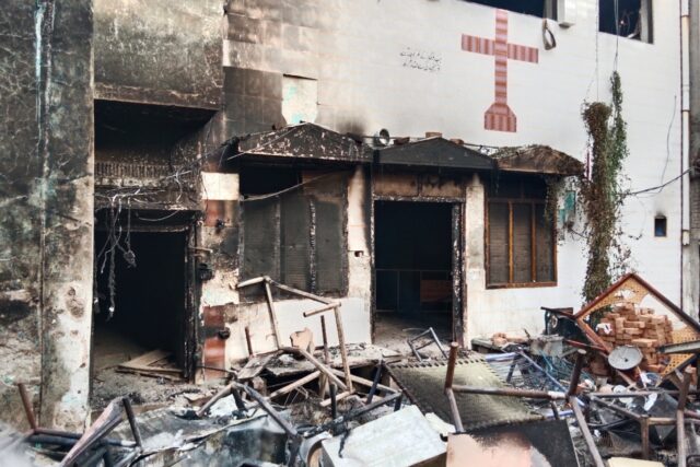View of a burnt church on the outskirts of Faisalabad, Pakistan, on August 16, 2023, follo