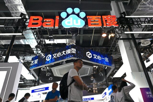 Visitors walk past the Baidu booth during the World Artificial Intelligence Conference (WA