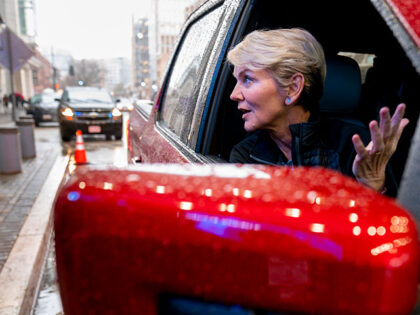 Energy Secretary Jennifer Granholm gets into the passenger seat after test driving a Ford