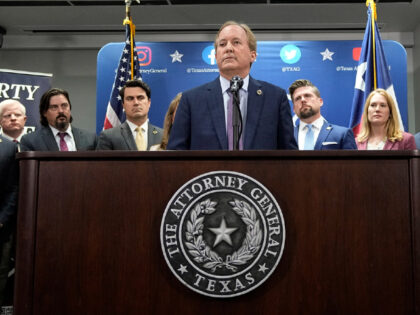 Texas state Attorney General Ken Paxton, center, makes a statement at his office in Austin, Texas, Friday, May 26, 2023. (AP Photo/Eric Gay)