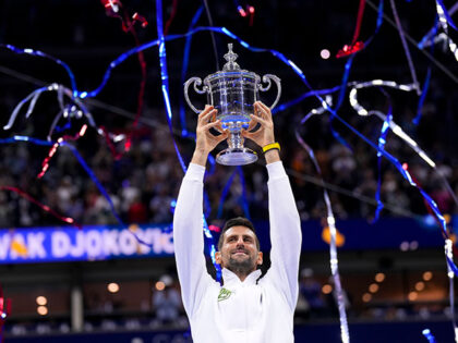 Novak Djokovic, of Serbia, holds up the championship trophy after defeating Daniil Medvedev, of Russia, in the men's singles final of the U.S. Open tennis championships, Sunday, Sept. 10, 2023, in New York. (AP Photo/Manu Fernandez)