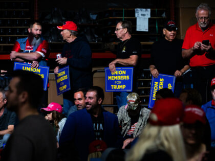 Attendees hold signs supporting former US President Donald Trump during a campaign event a
