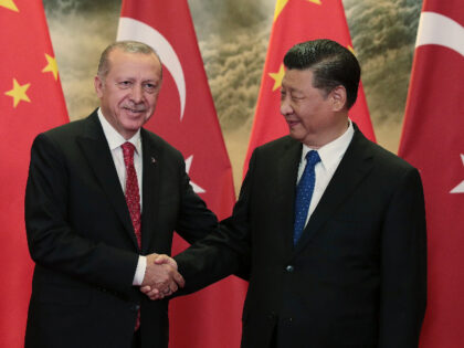 Chinese President Xi Jinping, right, and Turkish President Recep Tayyip Erdogan shake hand