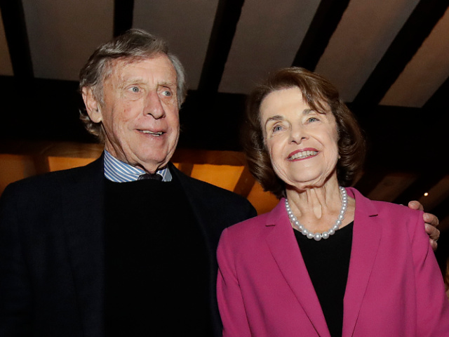 FILE - In this Nov. 6, 2018, file photo, U.S. Sen. Dianne Feinstein, right, smiles next to husband Richard Blum at an election night event in San Francisco. Sen. Feinstein's husband, University of California Regent Richard Blum, was named Thursday, Sept. 24, 2020, by the state auditor's office as one of the regents involved in admissions scandal where UC wrongly admitted dozens of wealthy, mostly white students as favors to well-connected people. (AP Photo/Jeff Chiu, File)