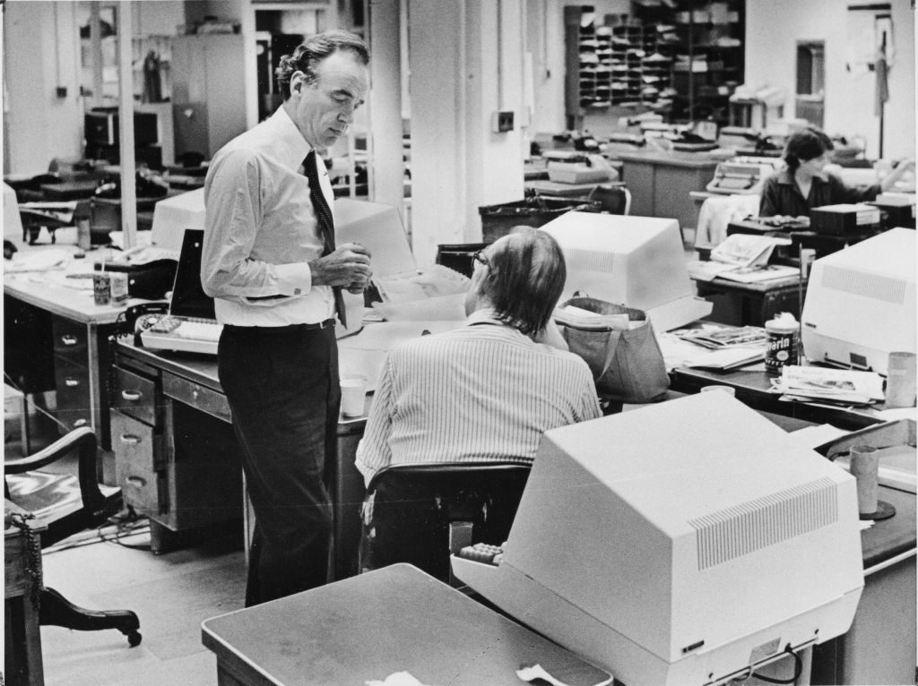 New York, N.Y.: Rupert Murdoch stands in the newsroom of the New York Post in Manhattan as he talks with Alan Whitney, the paper's Day Managing Editor as they prepare to get the paper ready following the strike in this October 4, 1978 photo. (Photo by Naomi Lasdon/Newsday RM via Getty Images)
