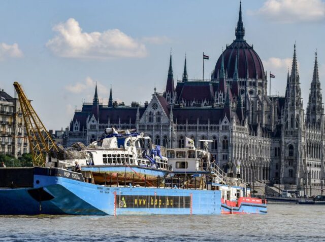 The recovered sunken Mermaid sightseeing boat is transported past the Hungarian parliament