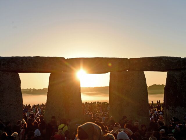 AMESBURY, ENGLAND - JUNE 21: Visitors celebrate summer solstice and the dawn of the longest day of the year at Stonehenge on June 21, 2019 in Amesbury, England. Visitors and modern day druids gather at the 5,000 year old stone circle in Wiltshire to see the sunrise on the Summer …