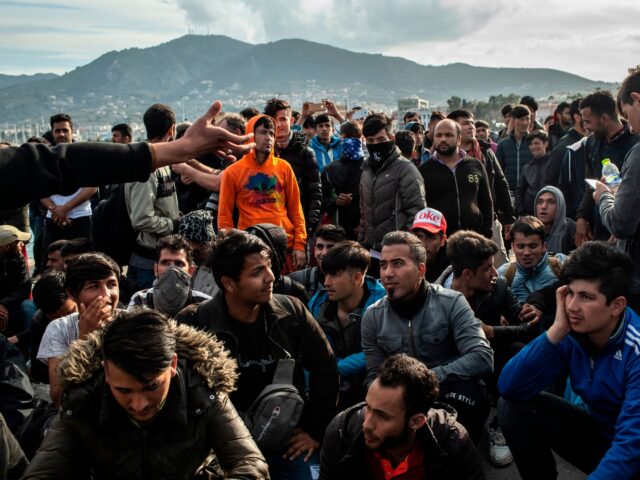 Migrants block a road outside port of Lesbos, on March 3, 2020, amid a migration surge fro