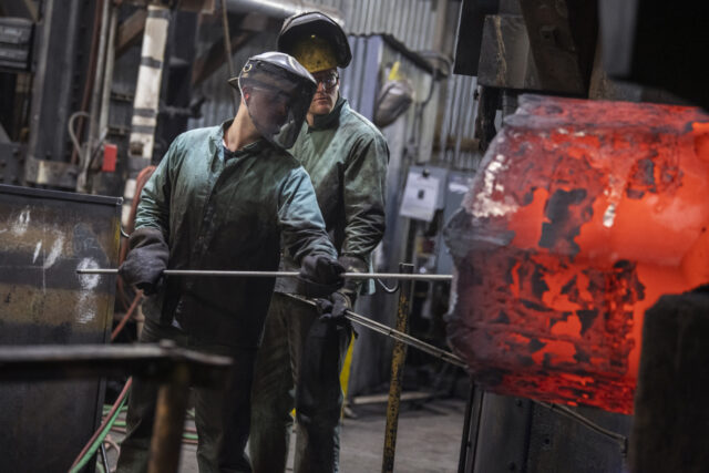 UNITED STATES - JUNE 2: Steelworkers attend to rolled steel at Lehigh Heavy Forge as Secre