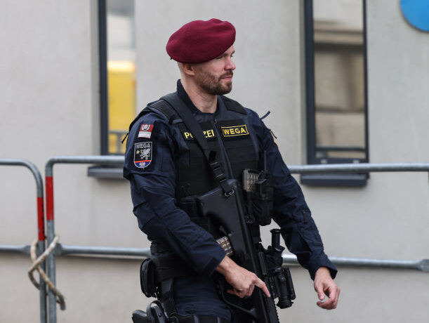 An armed police officer patrols outside the OPEC Secretariat building ahead of the 33rd me