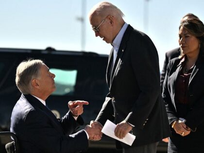 US President Joe Biden shakes hands with Texas Governor Greg Abbott after Abbott handed him a letter outlining the problems on the southern border upon arrival at El Paso International Airport in El Paso, Texas, on January 8, 2023. (Photo by Jim WATSON / AFP) (Photo by JIM WATSON/AFP via …