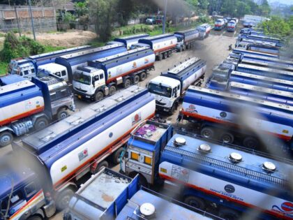 Trucks wait outside the Guwahati Refinery operated by Indian Oil Corporation, in Guwahati on March 30, 2023. - On March 29 Russian oil giant Rosneft announced a deal with Indian Oil to substantially increase oil supplies to the firm. India has emerged as a major buyer of Russian oil since …