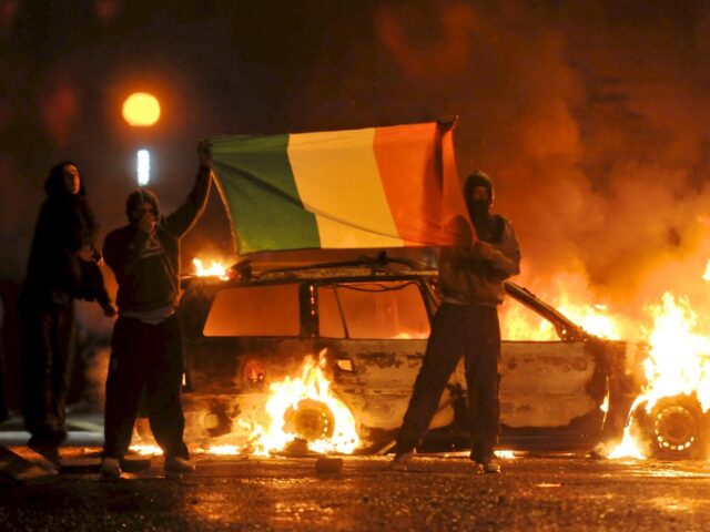 Cars burn during Nationalist rioting in the Ardoyne area of North Belfast, Northern Ireland on July 12, 2010. The rioting started after the police forced the Protestant Orangemen's traditional 12 July parade against the wishes of a group of Nationalist residents. AFP PHOTO STEPHEN WILSON (Photo by STEPHEN WILSON / …