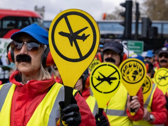 Extinction Rebellion 'Landing Crew' spell out the words 'Emergency Rebellion' in a protest