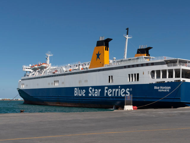 Port of Heraklion, Crete, Greece, Blue and white ferry with loading ramps down alongside i