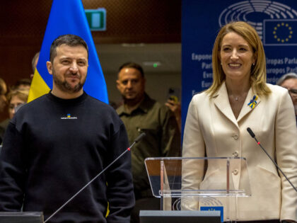 BRUSSELS, BELGIUM - FEBRUARY 09: Ukrainian President Volodymyr Zelensky (left) stands with the President of the European Parliament Roberta Metsola (center) as he is applauded by MEPs on his arrival in the hemicycle of the European Parliament on February 09, 2023 in Brussels, Belgium. Ukrainian President Volodymyr Zelensky visits Brussels …