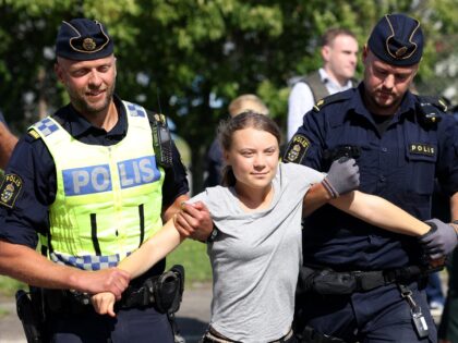 TOPSHOT - Climate activist Greta Thunberg is carried away by police officers after she took part in a new climate action in Oljehamnen in Malmo, Sweden on July 24, 2023, shortly after the city's district court convicted and sentenced her to a fine for disobeying police at a rally last …