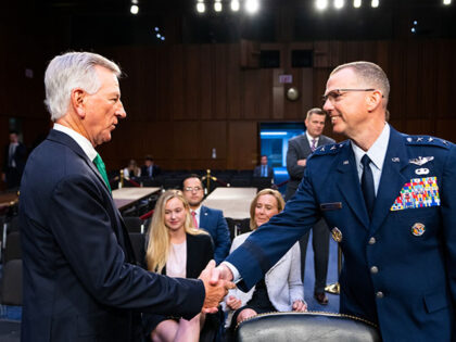 Sen. Tommy Tuberville, R-Ala., shakes hands with Air Force Lt. Gen. Gregory M. Guillot before the start of the Senate Armed Services Committee confirmation hearing on the nominations of Lt. Gen. Gregory M. Guillot, nominee to be general and commander of the U.S. Northern Command and commander of the North …