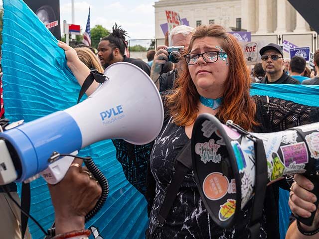 Lauren Handy, a member of Progressive Anti-Abortion Uprising, wears a cape as an anti-abor