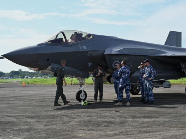 Soldiers stand beside a Royal Australian Air Force F-35A Lighting II at Antonio Bautista A