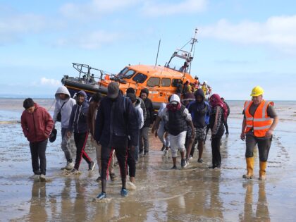 A group of people thought to be migrants are brought in to Dungeness, Kent, by RNLI lifebo